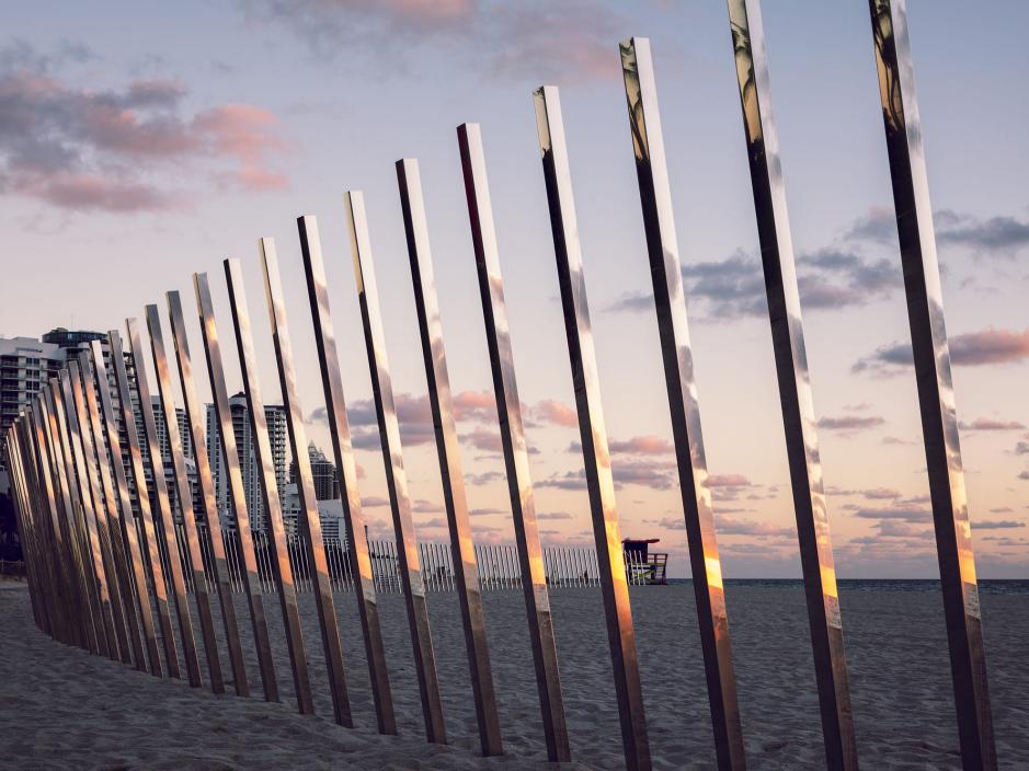 Reflective metal posts on the beach 