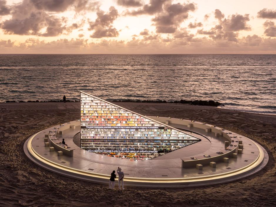 A few people looking at the rotating library at sunset in Miami Beach