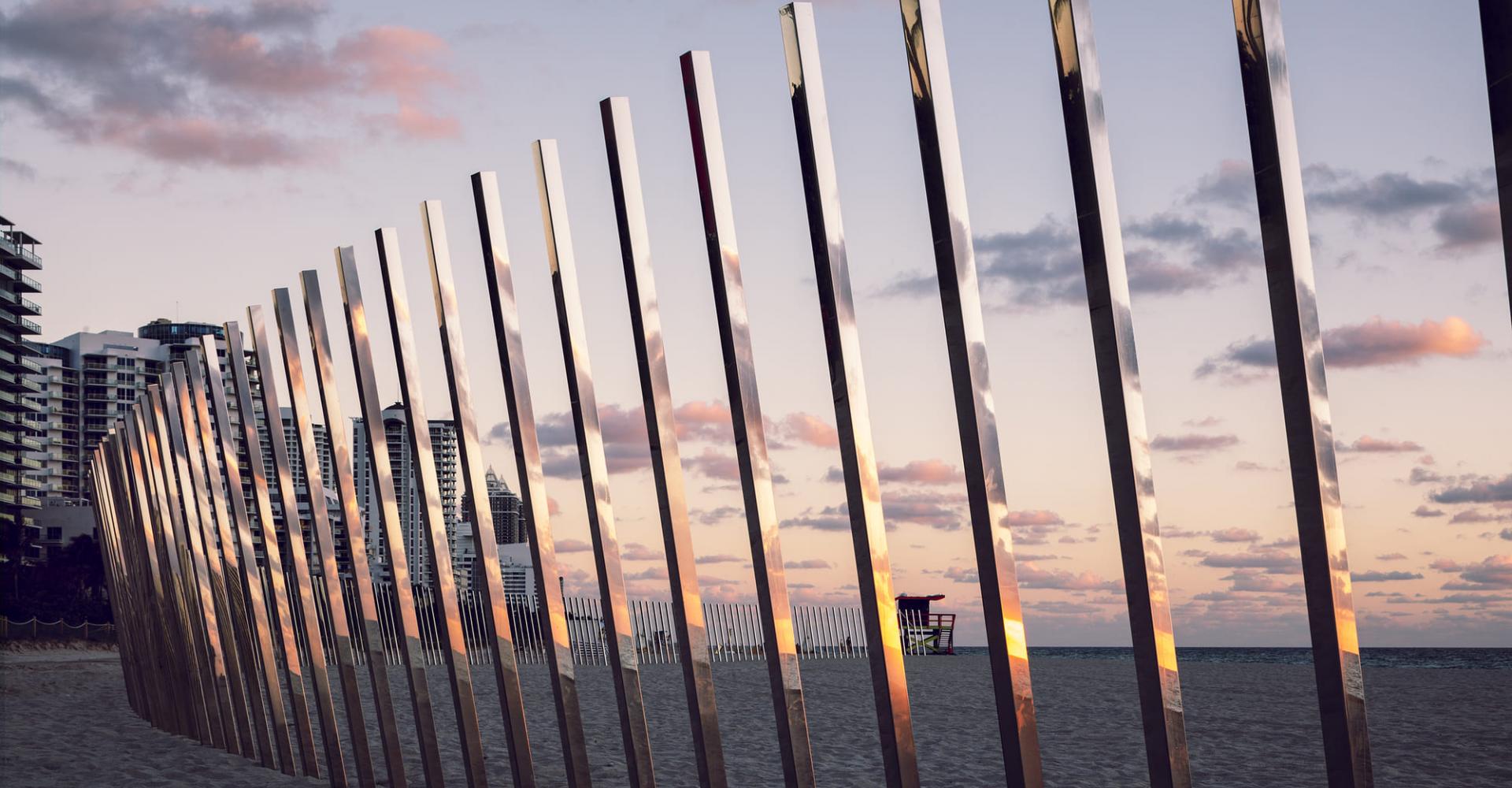 Reflective metal posts on the beach 