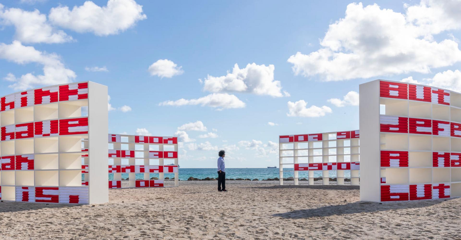 Man standing in the middle of an art installment on the beach