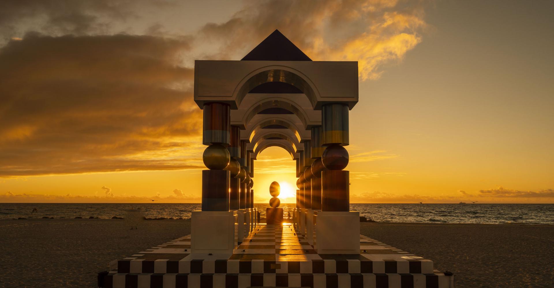 art feature on the beach with sunset in the background